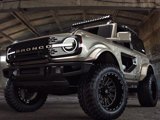 A gold Ford Bronco with the TIS logo and featuring TIS wheels with TIS-TT1 tires