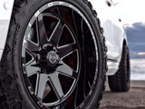 A close-up of the TIS-TT1 With a TIS OFFROAD wheel on a white Cadillac Escalade